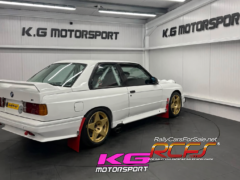 Pink KG Motorsport logo beneath showroom car
